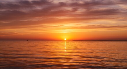 Fototapeta premium Vibrant Orange Sunset Over Calm Ocean Water