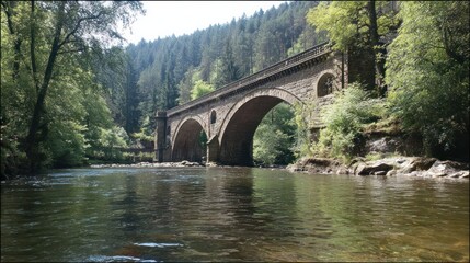 Stone bridge over a calm river in a lush valley