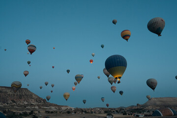 Hot Air Balloons in Cappadochia, Turkey as seen from a hot air balloon above the rock formations of Cappadochia