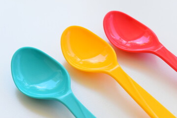 colorful spoon isolated on white background, plastic cutlery for picnic