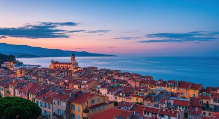 Naklejka premium Coastal town at sunset, terracotta roofs, hazy sky