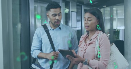 woman tapping tablet showing sustainability icons as colleague watching nodding approval for pitch - Powered by Adobe