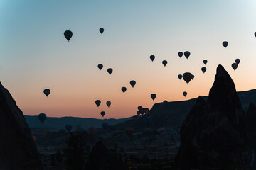 Hot Air balloons floating over Goreme at sunrise in Cappadochia, Turkey
