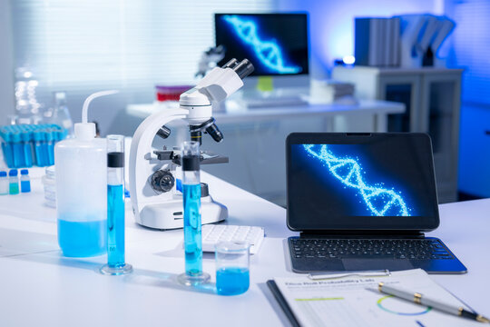 Laboratory equipment displaying dna structure on laptop and monitor
