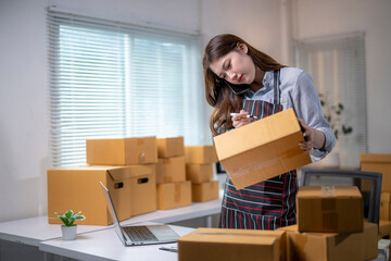 Young entrepreneur taking orders and managing her online store