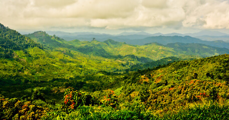 beautiful view of green mountain landscape with white clouds in the background