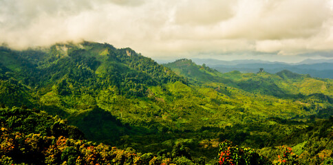 beautiful view of green mountain landscape with white clouds in the background