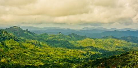 beautiful view of green mountain landscape with white clouds in the background