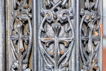 Ornate ironwork with intricate floral patterns and weathered details