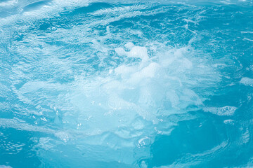 Air bubbles in clear blue water in pool for backgrounds.