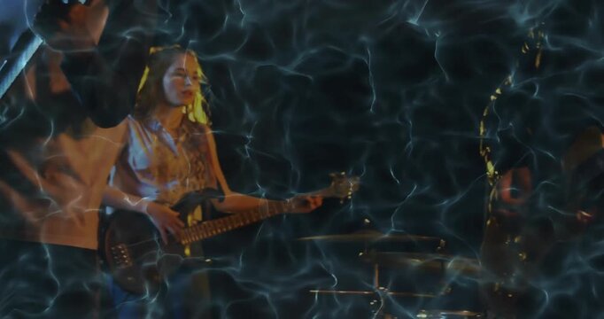 Band playing on stage with rippling water overlay as bassist plucking riff and singer grabbing mic