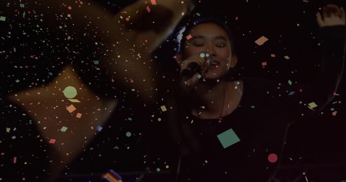 Concert singer singing intro backlit sparking confetti as fans reaching and leaning engaging them