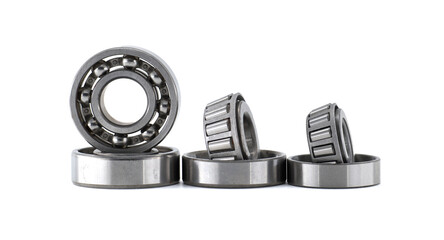 Set of ball bearings and roller bearings standing and laying on white background