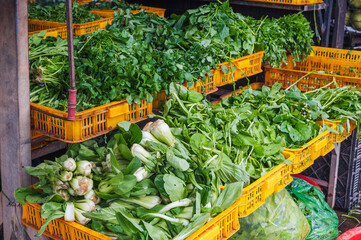 assortment of fresh herbs and salad greens at a farmer's vegetable market in Asia in Vietnam