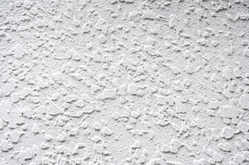 background with a texture of white textured plaster. Abstract decorative light pattern