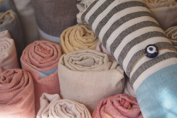 Colorful rolled textiles arranged in a display