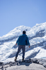 Man looking at snowy mountain peaks in the Andes
