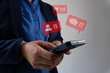 Business person with a cell phone and various social media icons such as favorite messages and social profiles