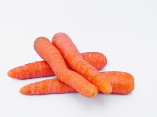Four fresh carrots photographed using a white background.