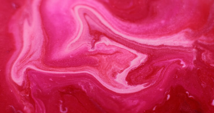 Shiny particles. Paint water. Defocused pink red crimson color shimmer ripple acrylic liquid floating on abstract art wet background.