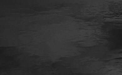 dark black background depicting a water surface in very low light at night. The surface has a very faint, soft sheen, typical of liquids.