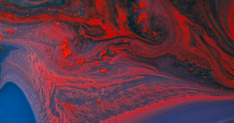 Flowing ink. Particles fluid. Defocused orange blue purple color wet shiny texture floating on abstract creative acrylic background.
