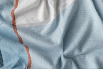Soft checkered blanket with folds creating cozy atmosphere
