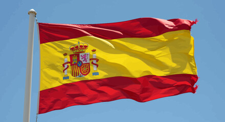 Close-up view of the national flag of Spain waving in the wind against blue sky