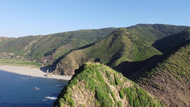 Aerial Nature mediterranean sea Landscape with Turquoise Sea or Ocean Bay and Empty Sand Beach. Beautiful Vacation and Tourism Destination Drone top view Pull in Video Shot in Jijel Algeria.