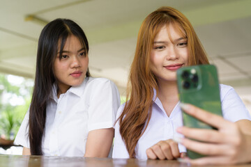 Young Thai University Students Relaxing Together at Campus Cafe Outdoors Taking Selfie Photo