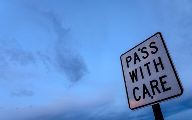 Pass with care sign