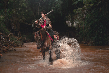 Brave Warrior on Horse Riding through Shallow River at Dusk