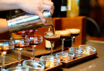 Creamy Espresso Martini Being Poured into Cocktail Glass
