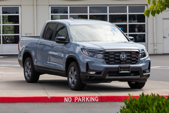 Beaverton, OR, USA - June 15, 2025 - Gray Honda Ridgeline AWD V6 pickup truck parked at a dealership. This unibody mid-size truck blends SUV comfort with truck utility, popular for urban use