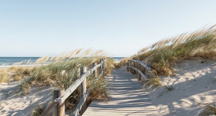Wooden boardwalk path to ocean beach with dunes and grass