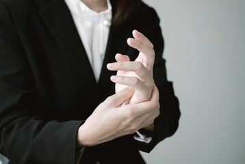 A young woman who works in an office has chronic palm pain due to office syndrome. Using a laptop for a long time causes numbness and pain in the palms, which should not be overlooked