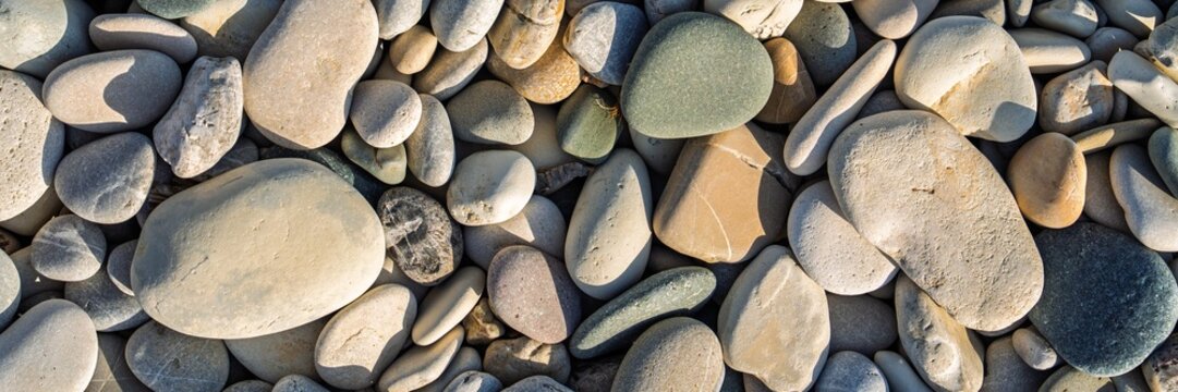 Smooth beach stones create a serene assortment perfect for wellness and design. Their diverse shapes provide an organic mosaic, ideal for zen gardens, meditation, and calming visuals. - Powered by Adobe