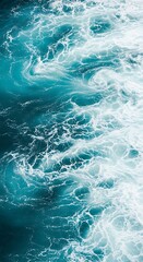Fototapeta premium Close up of turbulent turquoise ocean water with white foam and swirling patterns