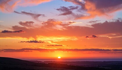 Vibrant Sunset Sky Over A Rolling Landscape Displaying Layers Of Orange And Blue Hues