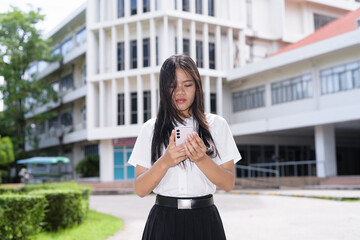 Thai Teenager Female Student Standing Outside University Building Using Phone