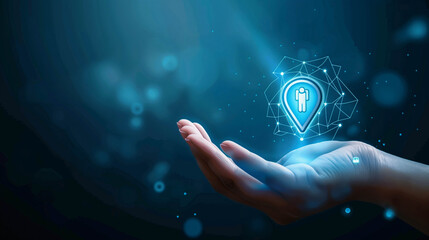 Futuristic digital location icon hovering above an open human hand with glowing lights