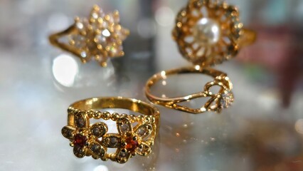 Glittering Collection of Gold Rings: Floral Designs and Gemstone Accents, Sparkling Gold Rings with Intricate Patterns and Shiny Stones