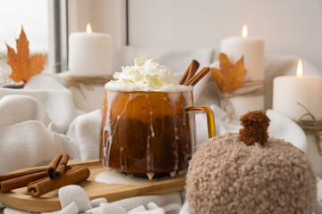 Autumn hygge Orange Cup of warm coffee autumn leaves on table against raindrops are running down the glass in window. Cozy fall still life footage burning candles. Thanksgiving and Halloween holiday