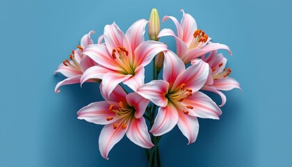 Fototapeta premium a vibrant bouquet of pink lilies with green stems, arranged in a vase with water and set against a backdrop that transitions from blue to gray.