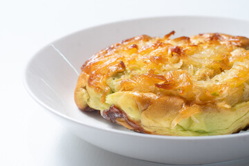 Coconuts bread in white bowl on white background