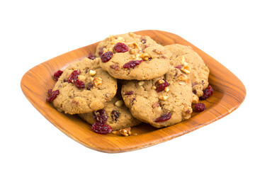 a plate of cookies with cranberries and walnuts
