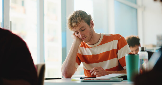 Sleeping, notebook and tired with man in classroom for failed exam, student stress and adhd crisis. College burnout, dreaming and lecture with person with a learning disability or test anxiety