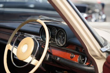 Vintage Classic car steering wheel, with chrome and leather textures in sharp detail, showcases the...