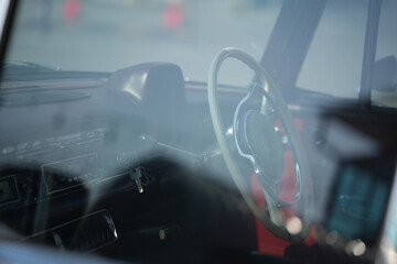 Vintage Classic car steering wheel, with chrome and leather textures in sharp detail, showcases the...