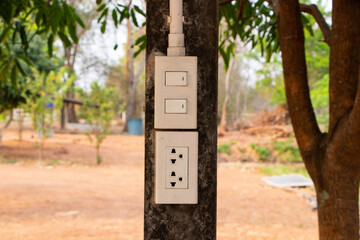 Box white electrical power switch off, on and plug energy with plastic pipe wiring on concrete pillar is blurred background. Turning Off Light Switch. Electrical safety concept technology.